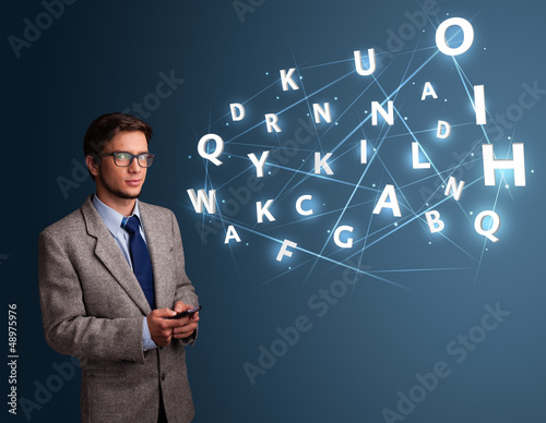 Photo: Young man typing on smartphone with high tech 3d letters comming Young man typing on smartphone with high tech 3d letters comming