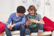 similing teenagers smiling at a phone message