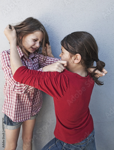 Photo: young girls quarrel at school young girls quarrel at school