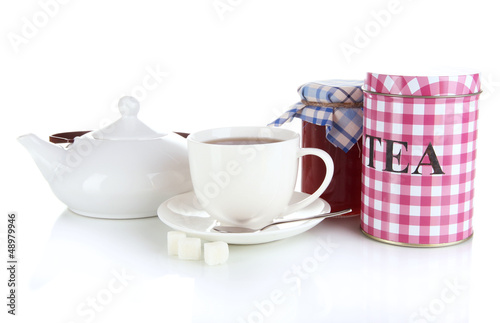 Photo: Jar and cup of tea isolated on white Jar and cup of tea isolated on white