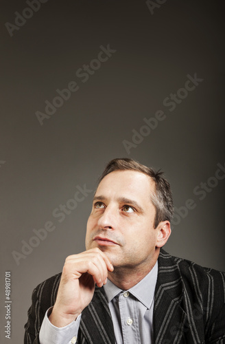 Photo: portrait of adult man isolated on dark background portrait of adult man isolated on dark background