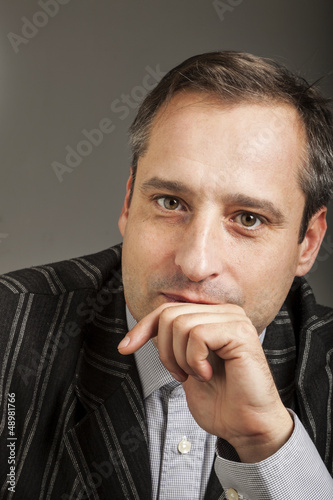 Photo: portrait of adult man isolated on dark background portrait of adult man isolated on dark background