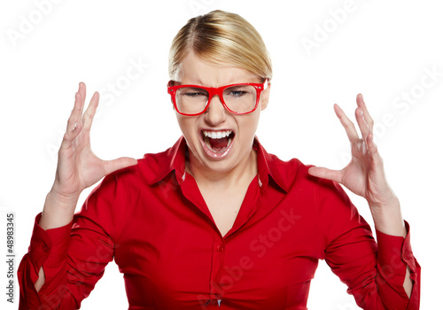 Photo: Female executive with confused expression standing over white ba Female executive with confused expression standing over white ba