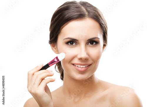 Photo: Smiling woman with make up brush, isolated Smiling woman with make up brush, isolated