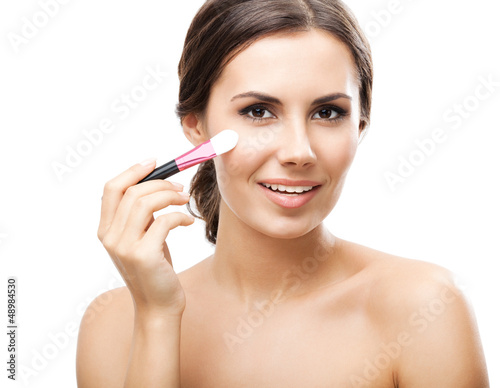 Photo: Smiling woman with make up brush, isolated Smiling woman with make up brush, isolated