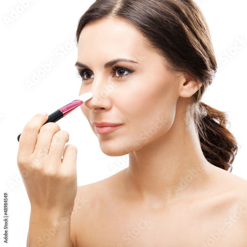 Photo: Smiling woman with make up brush, isolated Smiling woman with make up brush, isolated