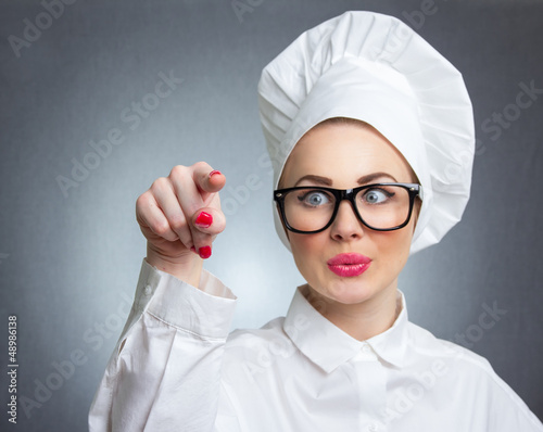 Photo: Woman cook chef touching space for your text Woman cook chef touching space for your text