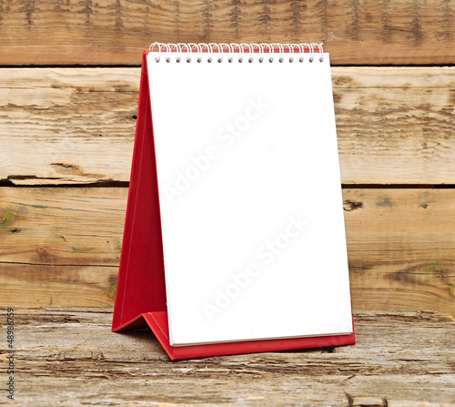 Photo: desk calendar on old wooden table desk calendar on old wooden table