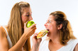 Thin and fat woman eating