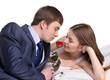 man, woman and red flower