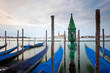 Chapel in water with moving gondolas, Venice, Italy