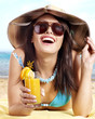 Photo: Girl in bikini on beach drinking cocktail. Girl in bikini on beach drinking cocktail.