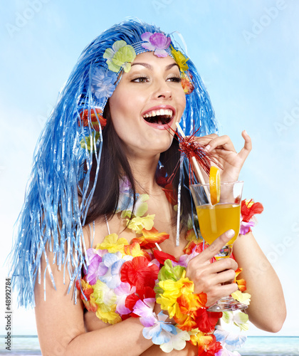 Photo: Woman in hawaii costume drink juice. Woman in hawaii costume drink juice.
