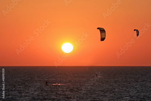 Photo: kitesurfers at sunset kitesurfers at sunset