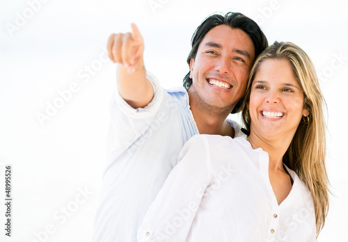 Photo: Happy couple pointing away Happy couple pointing away