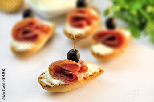 Photo: croutons with sliced salami cheese and olives croutons with sliced salami cheese and olives