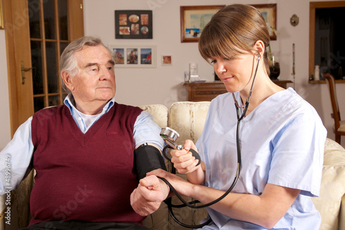 Photo: Krankenschwester misst Blutdruck bei Senior Krankenschwester misst Blutdruck bei Senior