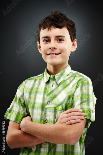 Photo: Young boy with his arms folded Young boy with his arms folded