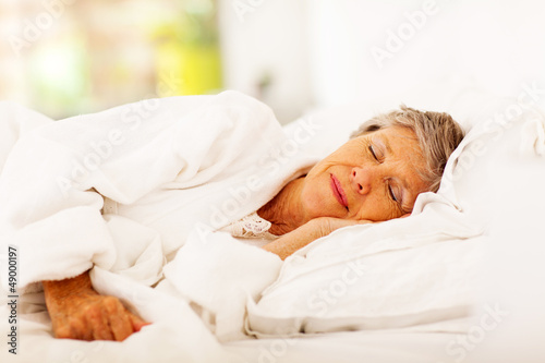 Photo: senior woman sleeping on bed senior woman sleeping on bed