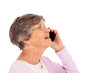 cheerful elderly lady talking on smart phone isolated on white