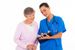 friendly young nurse helping senior woman with medical form