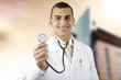 Smiling medical doctor with stethoscope on the hospitals backgro