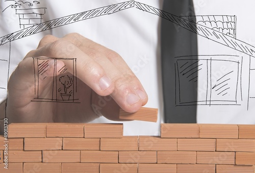 Photo: Businessman builds a new house Businessman builds a new house