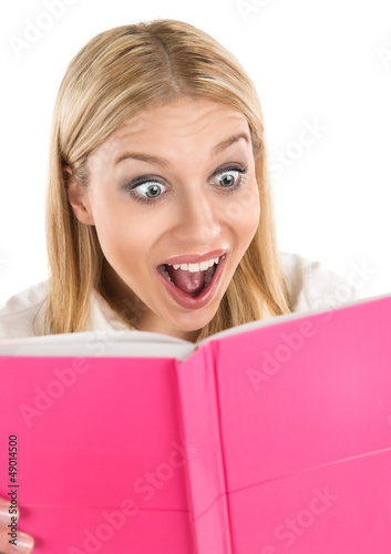 Photo: Shocked attractive woman reading book or diary Shocked attractive woman reading book or diary