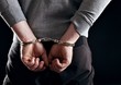 Outlaw's Hands Locked in Handcuffs
