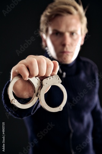 Photo: Cop with Handcuffs for Law Offenders Cop with Handcuffs for Law Offenders