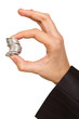 man's hand holding a stack of silver coins