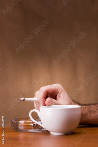 Photo: Hand holding a cigarette Hand holding a cigarette