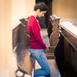 Photo: Young woman praying in a church Young woman praying in a church
