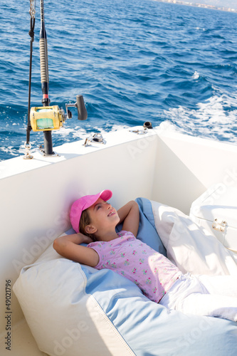 Photo: child girl sailing relaxed on boat deck ejoying a nap child girl sailing relaxed on boat deck ejoying a nap
