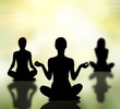 silhouettes of women practicing yoga lotus pose