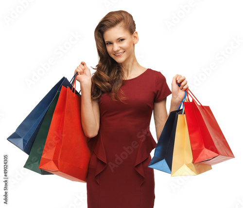 Photo: teenage girl in red dress with shopping bags teenage girl in red dress with shopping bags