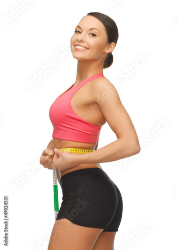 Photo: woman measuring her waist woman measuring her waist