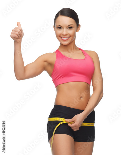 Photo: woman measuring her hips woman measuring her hips