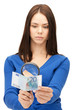 woman with magnifying glass and euro cash money