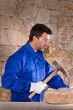 Masonry mason stonecutter man with hammer working