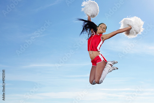 Photo: Young female cheerleader Young female cheerleader