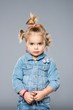 Photo: Funny little girl isolated on grey Funny little girl isolated on grey