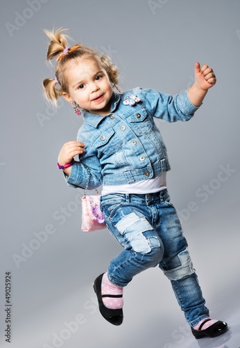 Photo: Funny little girl with small bag Funny little girl with small bag
