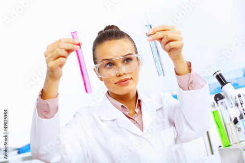 Photo: Young female scientist working in laboratory Young female scientist working in laboratory