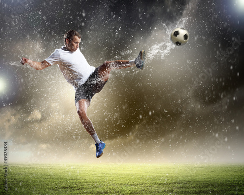 Photo: football player striking the ball football player striking the ball