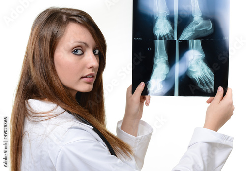 Photo: nice female doctor looking at X-ray image nice female doctor looking at X-ray image