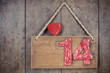 Vintage valentine heart and fourteen signboard on wooden wall