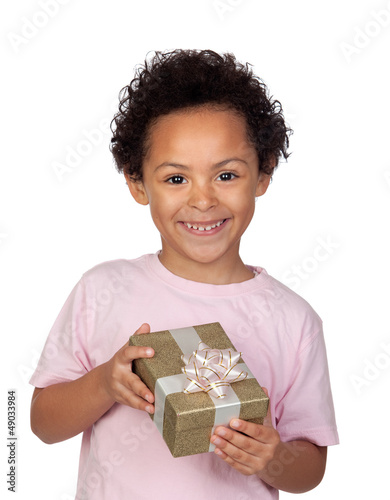 Photo: Happy latin child with a golden gift Happy latin child with a golden gift