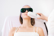 Young woman receiving epilation laser treatment