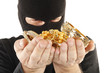 Masked man is holding stolen gold